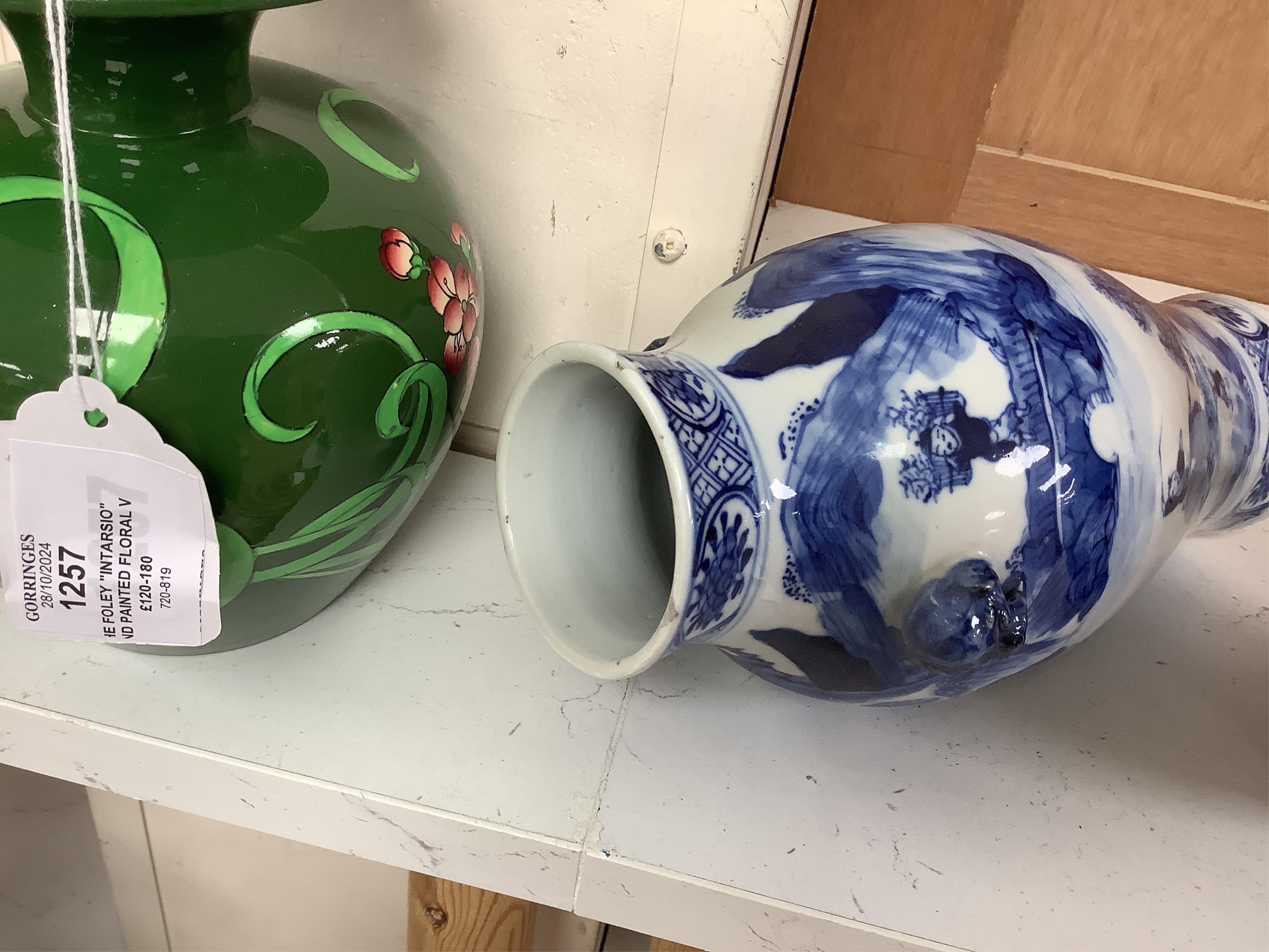 Late 19th century Chinese vases; pair of small Chinese blue and white moon flasks and a larger Chinese blue and white landscape vase, larger vase 22cm high. Condition - one moon flask handle restored, other items fair